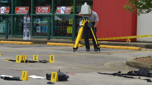 A TBI technician uses a laser mapper to document the crime scene connected to the shooting in East Tennessee