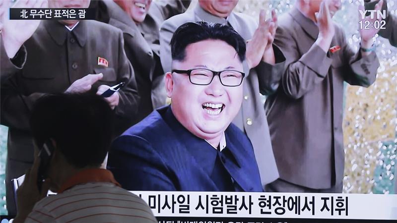 A TV news channel shows an image of North Korean leader Kim Jong-un