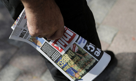 A man buy a newspaper from a kiosk in Istanbul Thursday