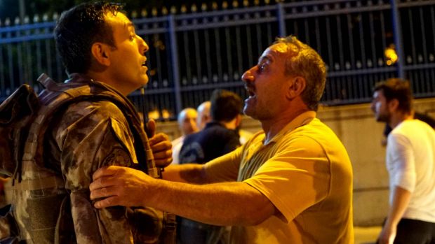 A man confronts a Turkish soldier at the Ataturk Airport's entrance in Istanbul on Friday