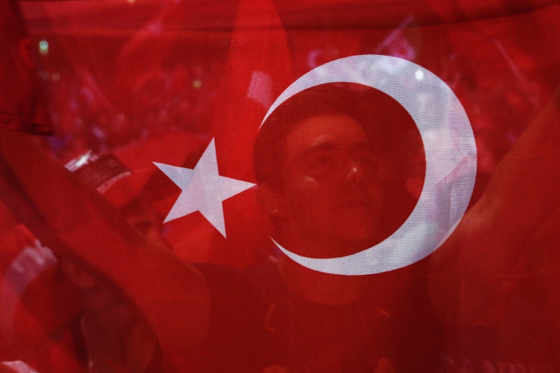 A man holds a Turkish flag during a rally at Taksim square in Istanbul Tuesday