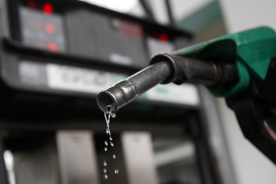 A man poses with a gasoline pump at a Budapest petrol stati