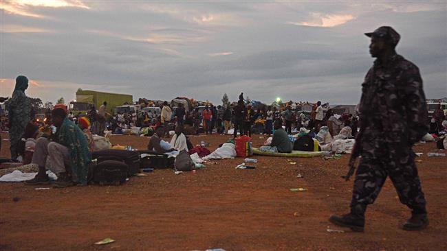 A military officer walks by evacuated people inside a makeshift camp at Nimule border in Amuru Distric in Uganda