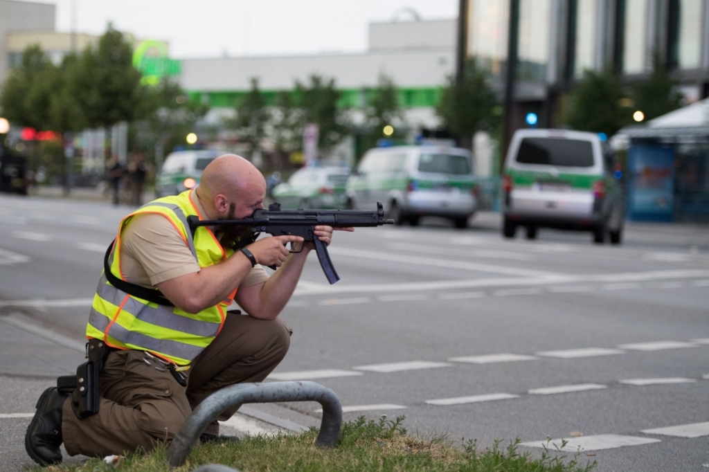 A police officer searching for the gunman following the mall massacre