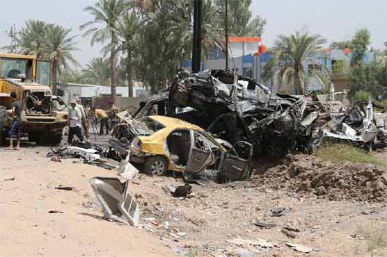 A suicide car bombing claimed by the IS group killed 12 people at a checkpoint north of Baghdad