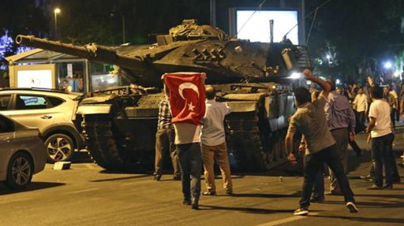 A tank moves into position as Turkish people attempt to stop them in Ankara Turkey