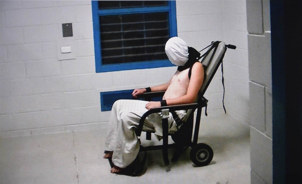 Image A teenage boy strapped into a chair