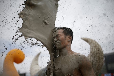 A tourist plays in mud during the Boryeong Mud Festival at Daecheon Beach in Boryeong South Korea on Saturday