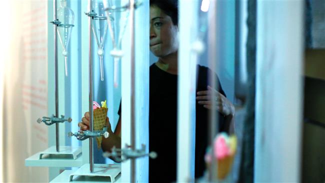 A woman serves Ice cream cones at the Museum of Ice Cream across from the Whitney Museum