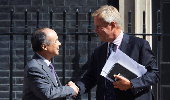 Masayoshi Son and Stuart Chambers shake hands