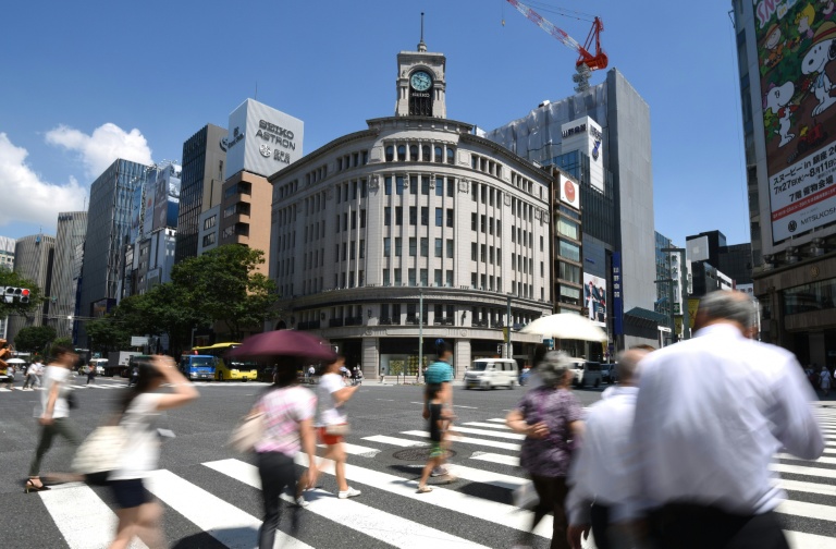 AFP  Toru Yamanaka People walk down a street in the Ginza shopping district of Tokyo