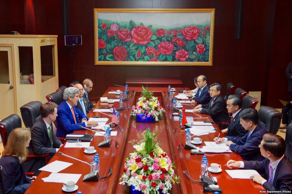 U.S. Secretary of State John Kerry addresses Chinese Foreign Minister Wang Yi and his delegation at the National Convention Center in Vientiane Laos