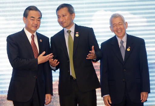 Chinese Foreign Minister Wang Yi left talks to Singapore's Foreign Minister Vivian Balakrishnan center and Philippine Foreign Secreatary Perfecto Yasay during the Association of Southeast Asian Nations –China Fore