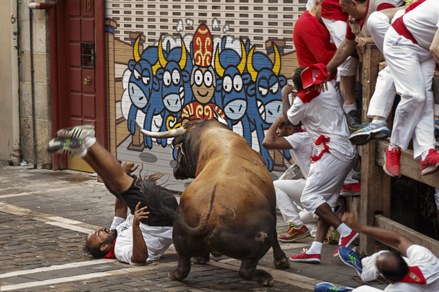 ASSOCIATED PRESS
A reveler is gored by a Cebada Gago's ranch fighting bull during the running of the bulls in Pamplona Spain 8 July