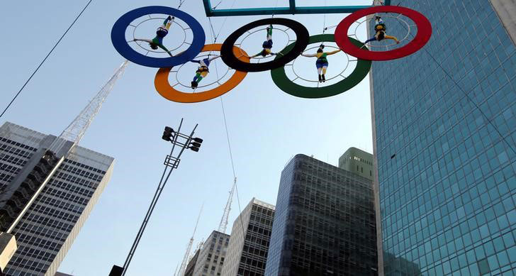 Acrobats perform on the Olympics rings at Paulista Avenue in Sao Paulo