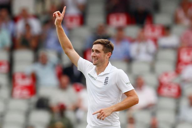 Chris Woakes celebrates after bowling and catching out Azhar Ali