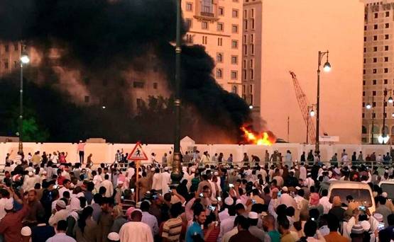 Muslim worshippers gather after a suicide bomber detonated a device near the security headquarters of the Prophet's Mosque in Medina Saudi Arabia