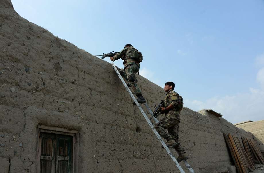 Afghan security forces patrol during ongoing clashes between the military and Islamic State militants in Kot District in eastern Nangarhar province