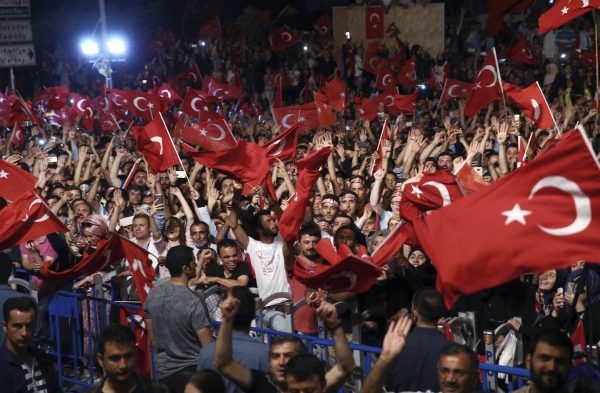 Supporters listen to Turkey’s President Recep Tayyip Erdogan as he addresses them in front of his residence in Istanbul early Tuesday