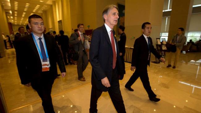 Britain's Chancellor of the Exchequer Philip Hammond walks to a meeting during the G20 finance ministers and central bank governors conference held in Chengdu in Southwestern China's Sichuan province