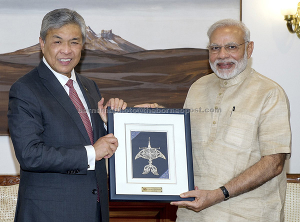 Ahmad Zahid presenting a memento to Modi during a meeting in New Delhi yesterday. — Bernama