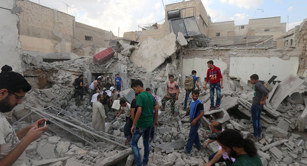 Men look for survivors under the rubble of a damaged building after an airstrike on Aleppo's rebel held Kadi Askar area Syria