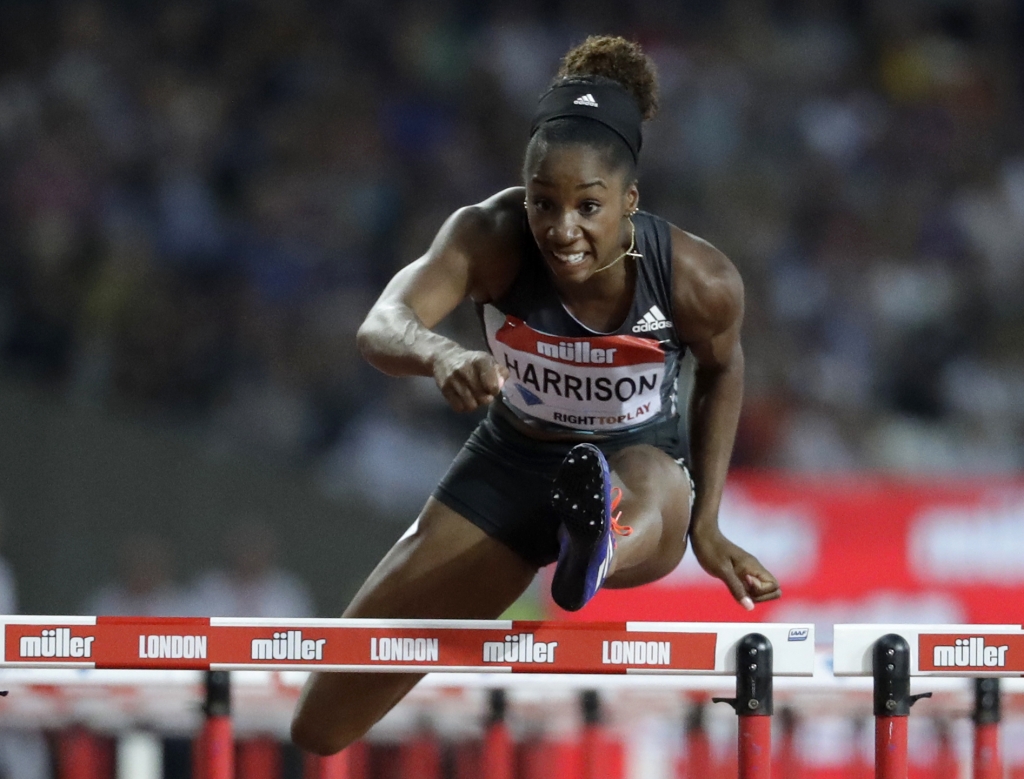 Kendra Harrison of the US clears the final hurdle as she runs on to win the women's 100 meter hurdles in a world record time of 12.20 seconds during the Diamond League anniversary games at The Stadium in the Queen Elizabeth Olympic Park in London Friday