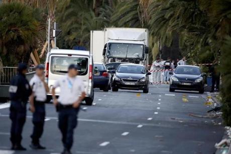 French police continue their investigation as they work near the heavy truck that ran into a crowd at high speed celebrating the Bastille Day July 14 national holiday on the Promenade des Anglais killing 80 people in Nice France