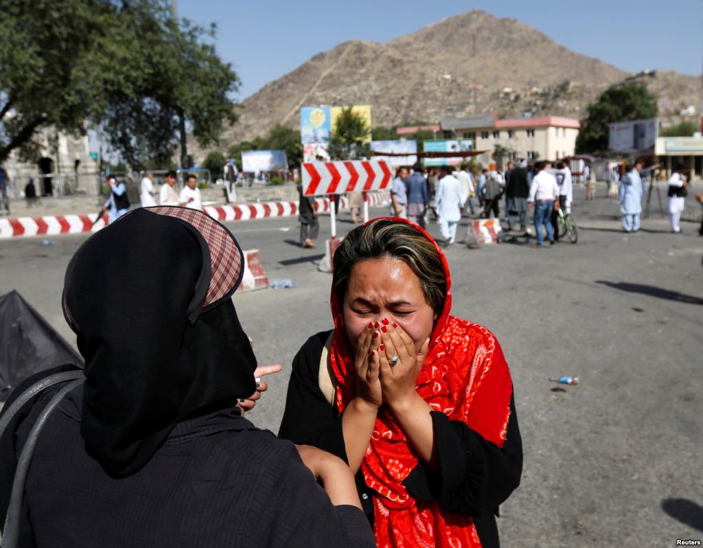 An Afghan woman weeps at the site of a suicide attack in Kabul Afghanistan