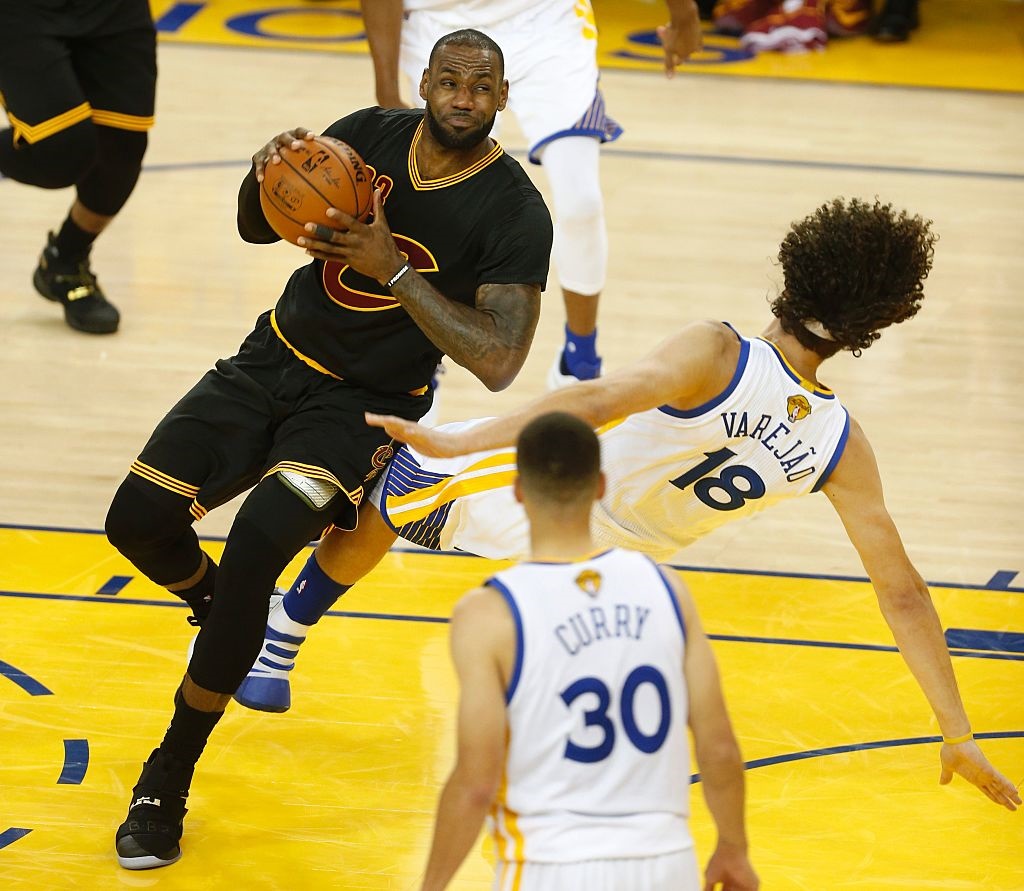 Cleveland Cavaliers forward Le Bron James collides with Golden State Warriors center Anderson Varejao during the second quarter of game 5 of the NBA Finals