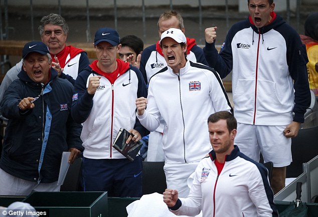 Andy Murray leads the cheers from the Great Britain team on the sidelines as Kyle Edmund secures victory