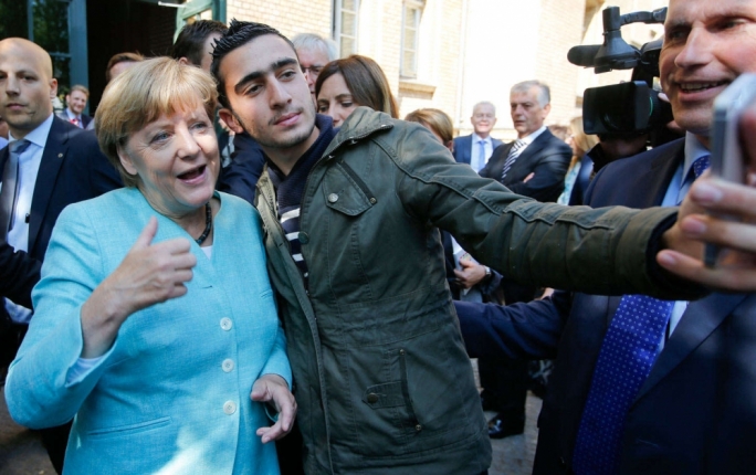 Angela Merkel has a selfie taken with a refugee during a visit to a refugee reception centre in Berlin in 2015