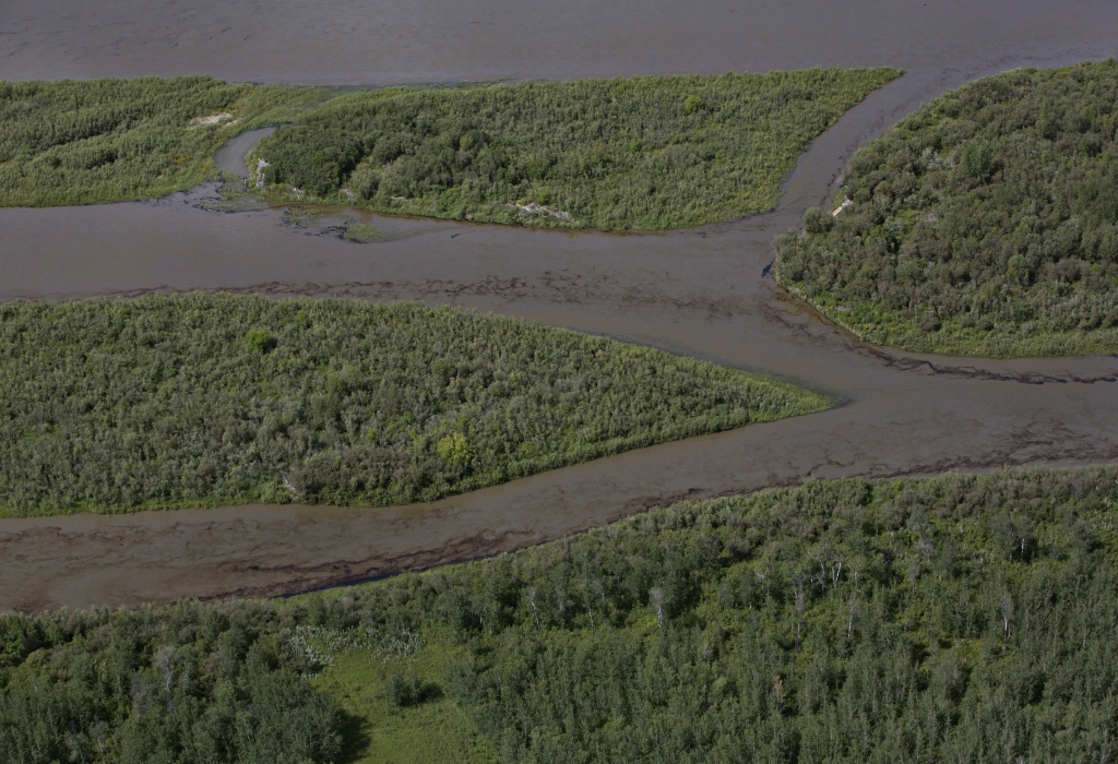 Husky Energy has said between 200,000 and 250,000 litres of crude oil and other material leaked into the river on Thursday from its pipeline. THE CANADIAN PRESS  Jaso