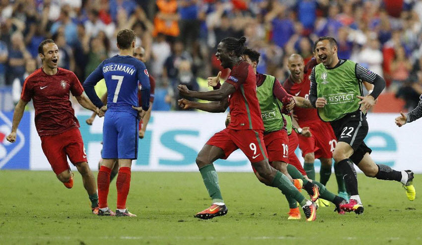 Antoine Griezmann stands dejected as Eder and Portuguese teammate celebrate the winning goal