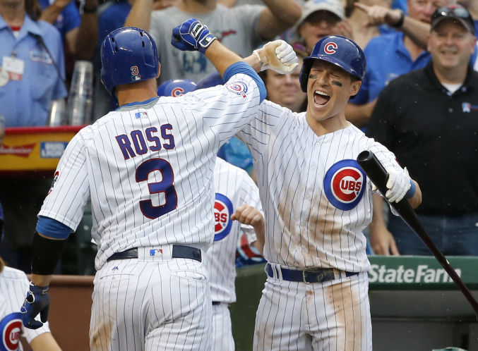 Former East Lake standout Chris Coghlan right celebrates with Cubs teammate David Ross after Ross homered in the sixth