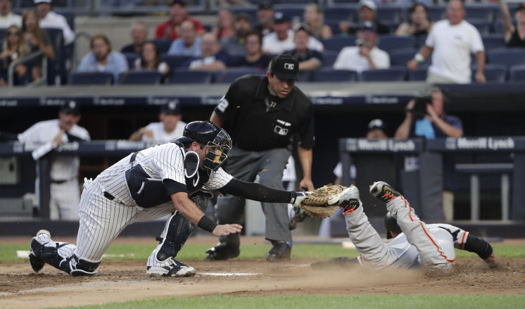 Yankees catcher Austin Romine misses the initial tag on Gregor Blanco then tags Blanco off the plate for the out