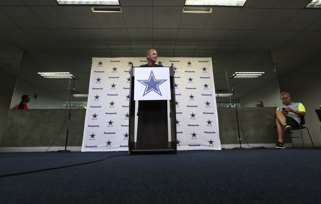 Dallas Cowboys head coach Jason Garrett center holds a news conference as Rich Dalrymple right vice president of public relations and communication sits by before the NFL football team's minicamp at Valley Ranch in Irving Texas Tuesday