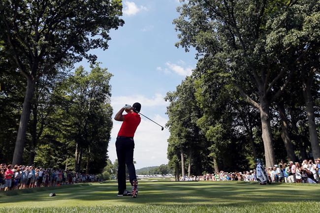 Jason Day watches his tee shot on the fifth hole during a practice round for the PGA Championship golf tournament at Baltusrol Golf Club in Springfield N.J. Wednesday