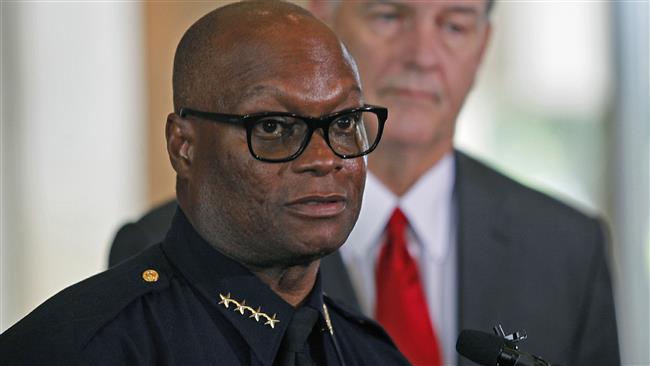 Dallas Mayor Mike Rawlings looks on during a press conference at Dallas City Hall as Dallas Police Chief David Brown speaks