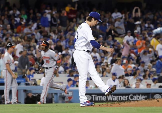 Los Angeles Dodgers starting pitcher Kenta Maeda reacts after giving up a three-run home run to Baltimore Orioles&#39 Manny Machado during the fifth inning of a baseball game Tuesday