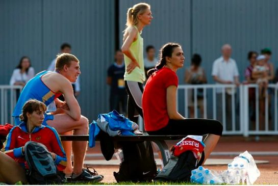 World Championships gold medalist Mariya Kuchina right rests with the other Russian athletes as she waits to make an attempt in the women's high jump during the Russian Stars 2016 track and field competitions in Moscow Russia Thursday