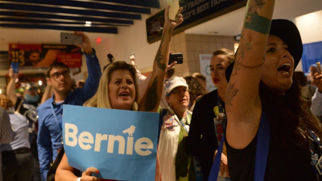 Bernie Sanders supporters walk out of the Democratic National Convention on Tuesday after Hillary Clinton became the official Democratic nominee