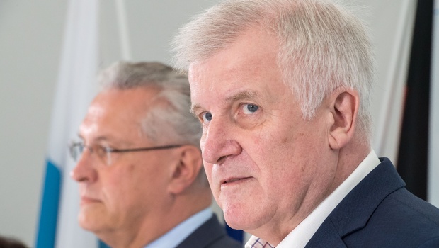 Bavarian governor Horst Seehofer,right and Bavaria's Interior Minister Joachim Herrmann attend a meeting of the Bavarian cabinet,in Gmund Germany