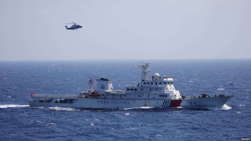 FILE- Chinese ship and helicopter are seen during a search and rescue exercise near Qilian Yu subgroup in the Paracel Islands which is known in China as Xisha Islands South China Sea