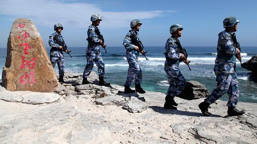 Soldiers of China's People's Liberation Army Navy patrol at Woody Island in the Paracel Archipelago which is known in China as the Xisha Islands