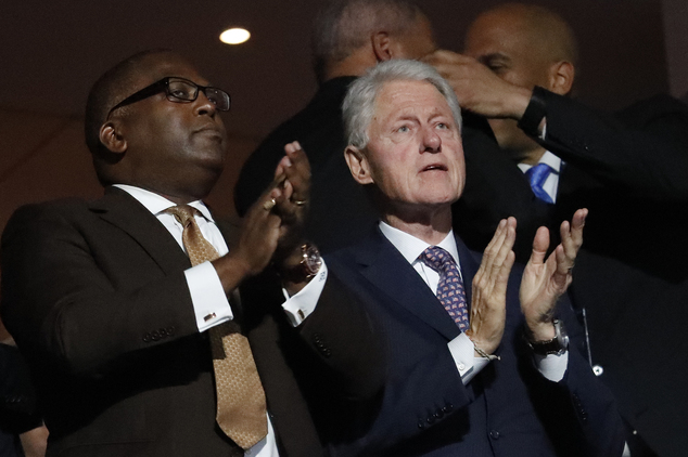 Former President Bill Clinton applauds as First Lady Michelle Obama speaks during the first day of the Democratic National Convention in Philadelphia, Monda