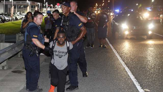 Police arrest activist De Ray McKesson during a protest along Airline Highway a major road that passes in front of the Baton Rouge Police Department headquarters Saturday