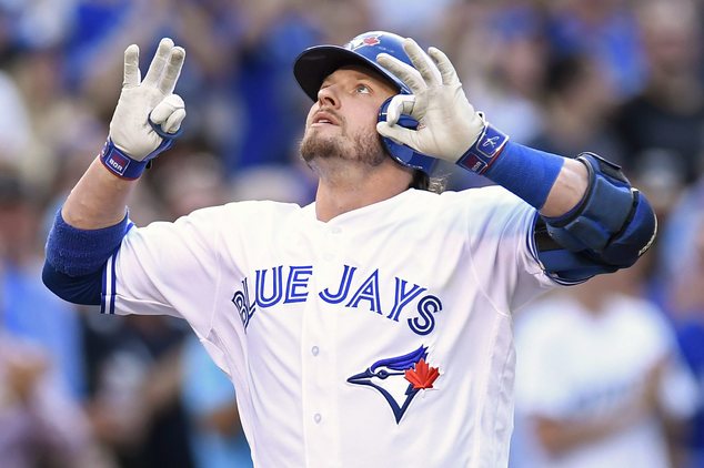 Toronto Blue Jays Edwin Encarnacion congratulates Josh Donaldson after hitting his second home run of the game against the Kansas City Royals during the thi