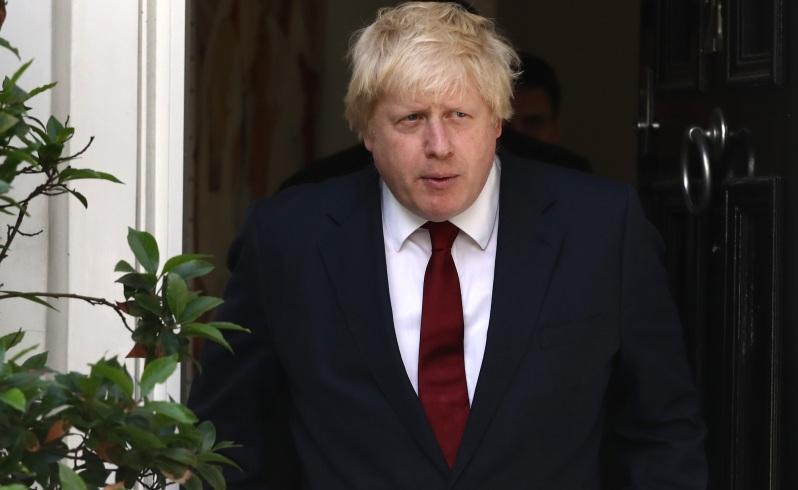 Boris Johnson leaves his house after British Prime Minister David Cameron resigned