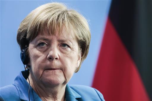 German Chancellor Angela Merkel attends a news conference with Irish Prime Minister Enda Kenny after a meeting at the chancellery in Berlin Germany Tuesday